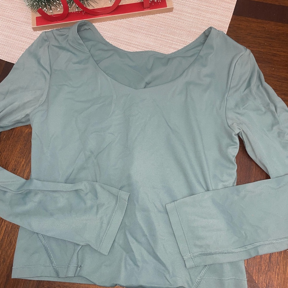 Woman’s size small green long sleeve top